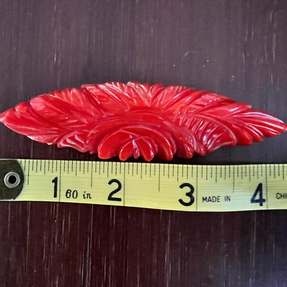 Vintage carved Bakelite dress clip/brooch in lipstick red stylized leaf.